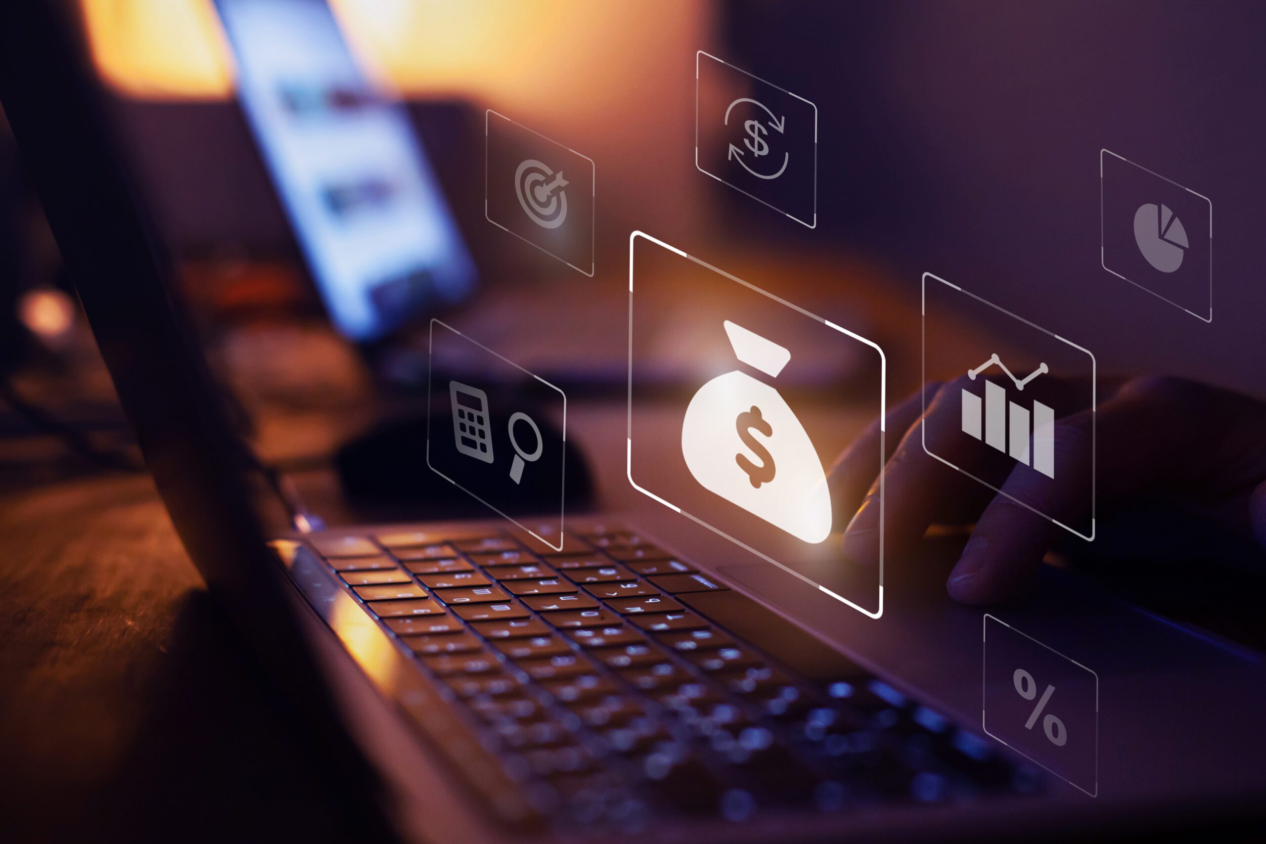 A laptop with money and finance icons overlaid.